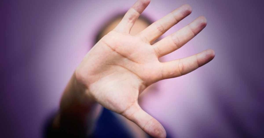 A woman holding up her hand