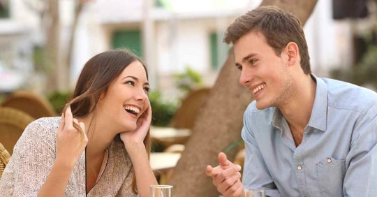 A man and woman smiling at each other.
