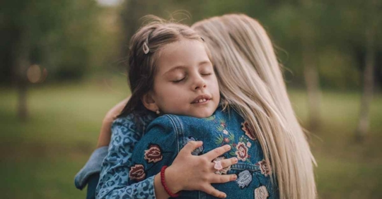 Mother and daughter hugging
