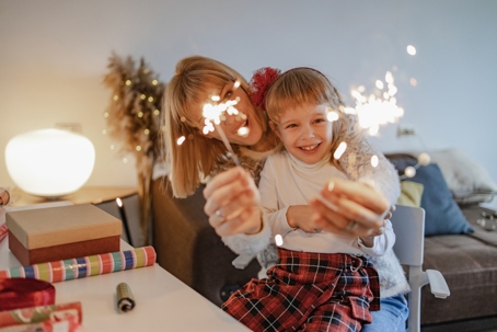 mother and daughter celebrating with sparklers
