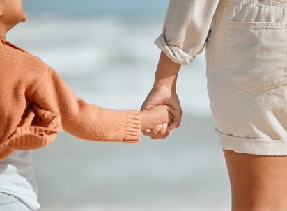 child holding parent's hand