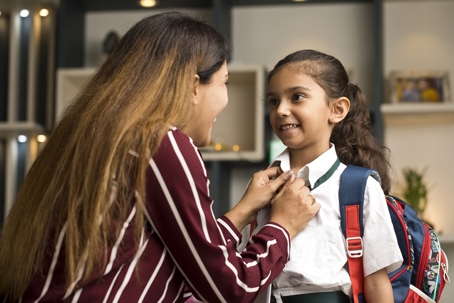 parent helping child get ready for school