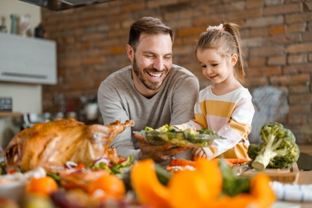 father and daughter preparing Thanksgiving meal
