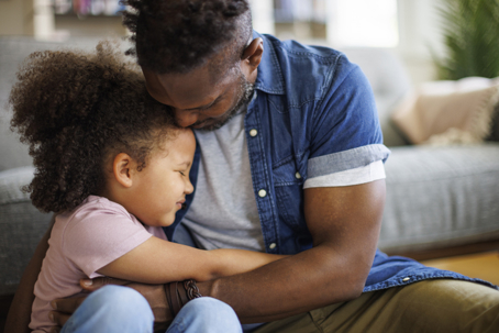 father hugging daughter