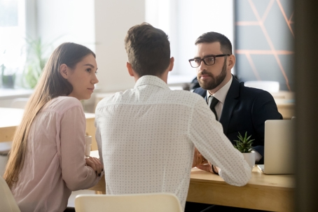 couple with a lawyer in his office